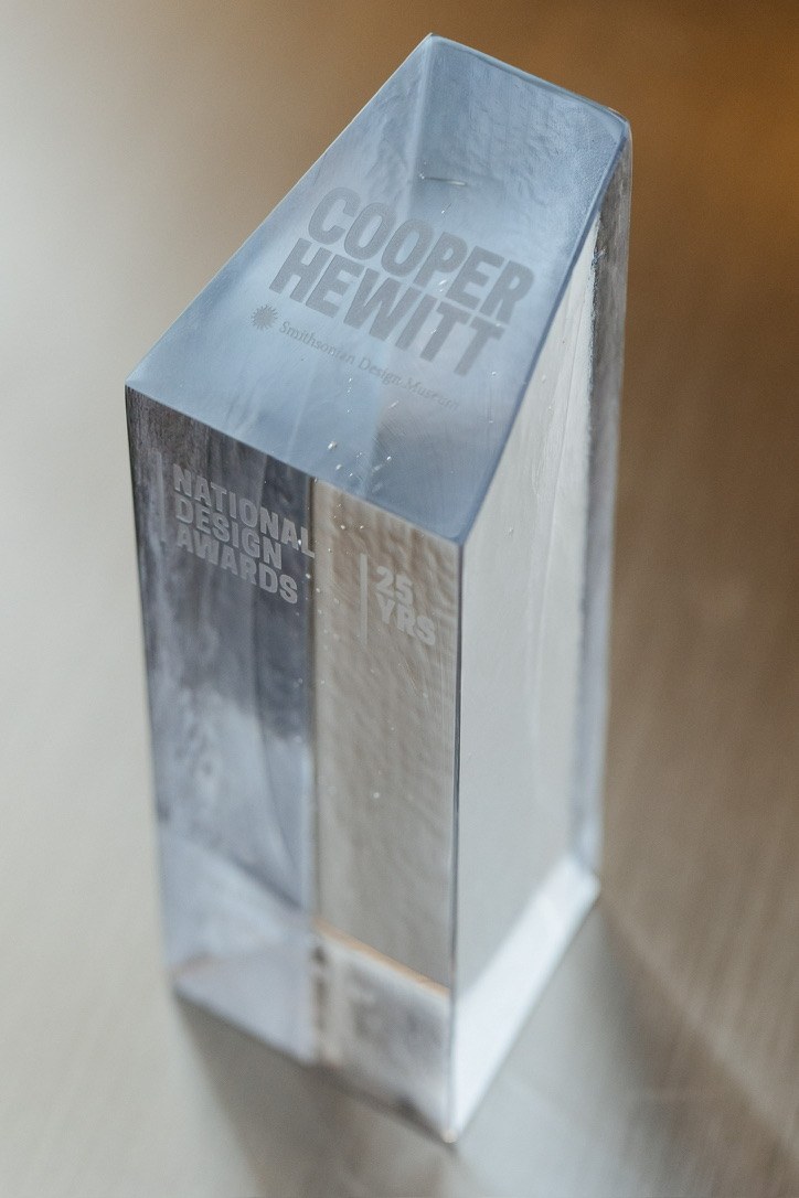 The Cooper Hewitt National Design Award: a tall frosted glass block etched with Cooper Hewitt, National Design Awards and 25 Yrs.