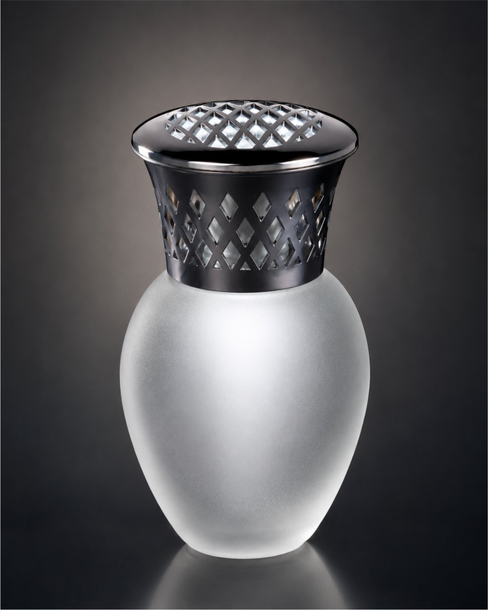 A frosted glass fragrance lamp with a black lattice collar and a polished silver cap, on a dark gray ground.