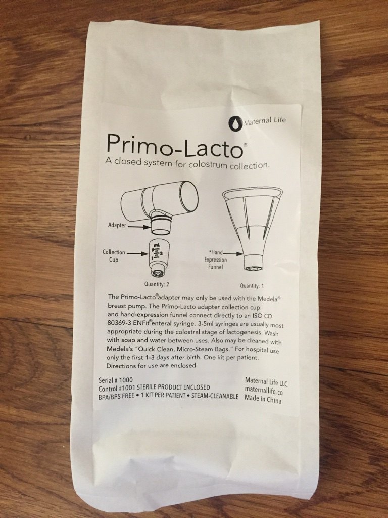 A white Primo-Lacto pouch from Maternal Life, printed with drawings of the adapter, two collection cups and the hand-expression funnel, and directions for use, on a wooden table.