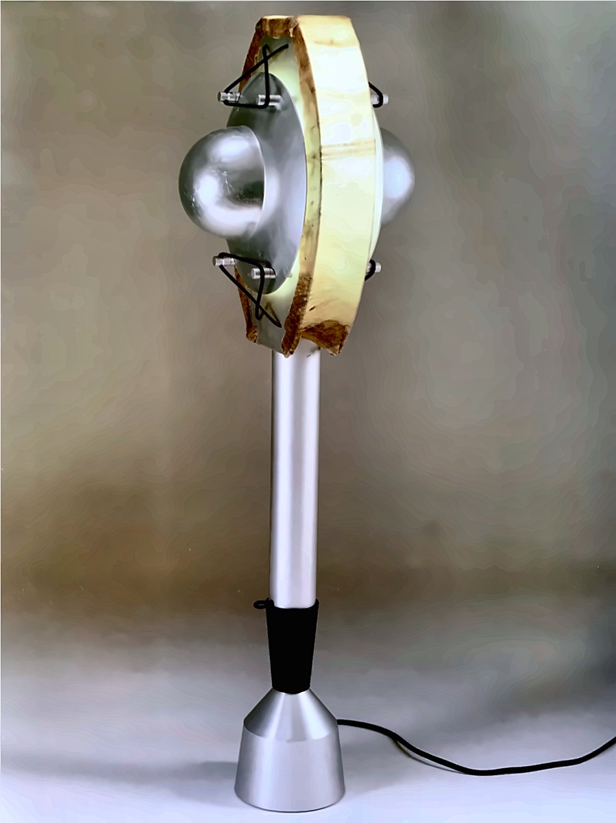 A table lamp with a brushed aluminum stem and cone base, topped by a curved pale wood shade around a silver sphere.