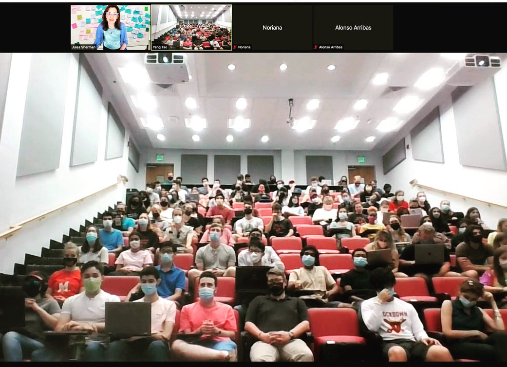 A full lecture hall of masked bioengineering students facing the camera on a video call, with Jules Sherman and Dr. Yang Tao in tiles along the top.